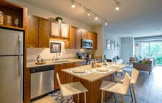 A modern kitchen with a dining table and chairs.