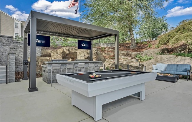 a billiards table in the backyard of a house