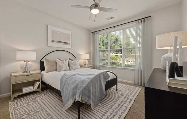 a bedroom with a bed and a ceiling fan