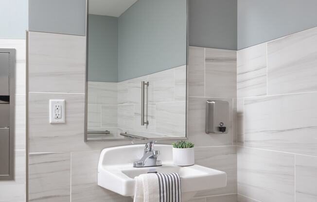 a white bathroom with a sink and a mirror