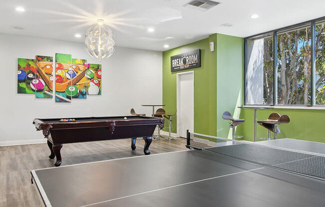 Community Clubhouse with Game Tables and Lounge Furniture at Madison Park Apartments located in Anaheim, CA.