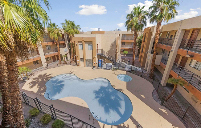 Experience resort-style living with this inviting courtyard's sparkling pool and lush palm surroundings.
