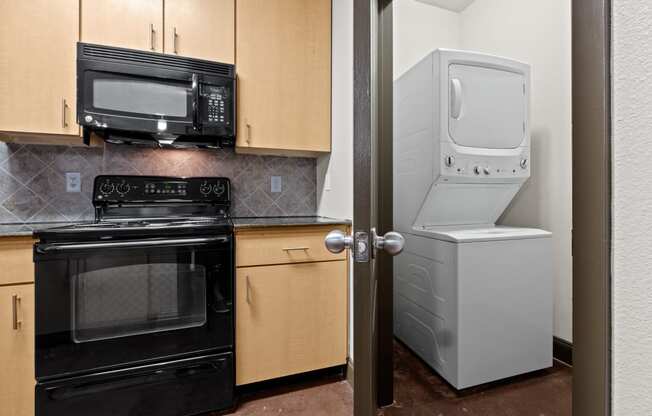 a kitchen with a refrigerator and a stove and a microwave