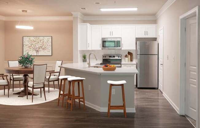 A kitchen with a table and chairs and a fridge.