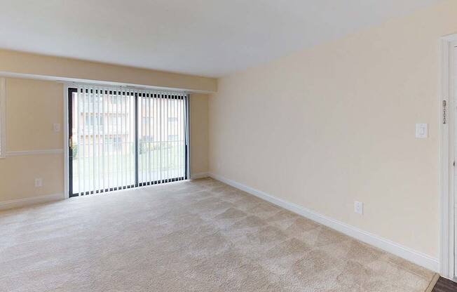 View of large living room area in apartment building with carpeting at Gainsborough Court Apartments, Fairfax, VA, 22030