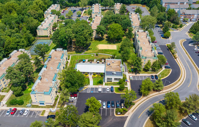 an aerial view of a neighborhood with cars parked in a parking lot