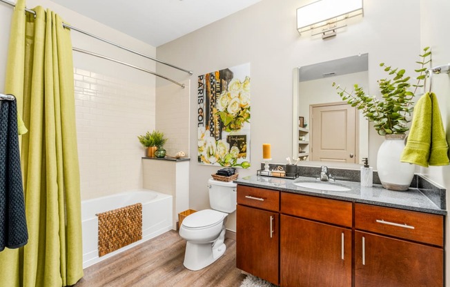 a bathroom with a toilet and a sink and a tub