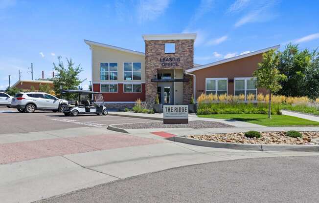 a building with a golf cart parked in front of it at Ridge at Thornton Station Apartments, Colorado, 80229