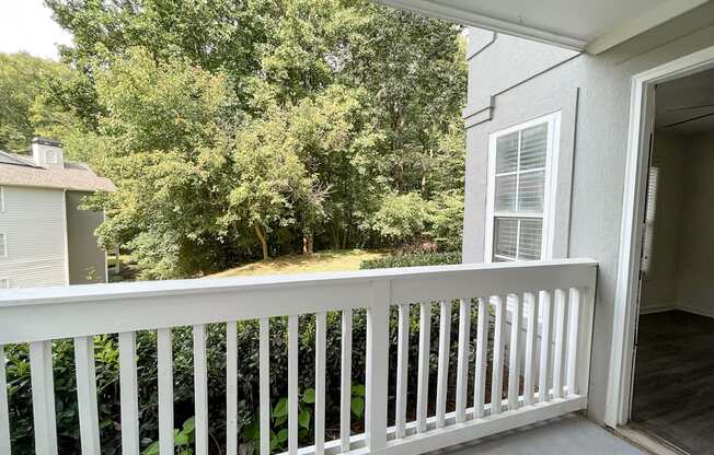 The Crest at Berkeley Lake St James renovated concrete patio with wooded view located in Duluth, GA 30096