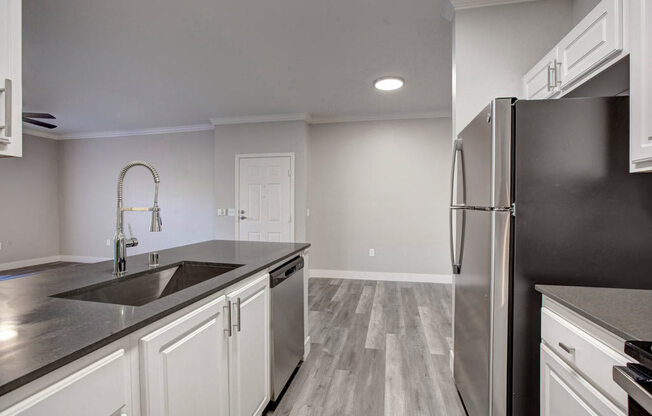 a kitchen with a sink and a refrigerator