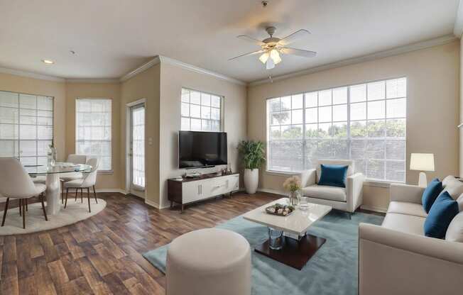 Light and bright living rooms with ample windows and hardwood floors at Turnberry Isle Apartments in Dallas, TX.