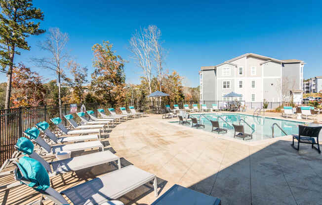 our apartments have a resort style pool with lounge chairs at Village at Westland Cove Apartments, Knoxville, TN, 37922