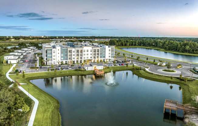 an aerial view of an apartment complex overlooking a lake at The Overlook, Winter Garden