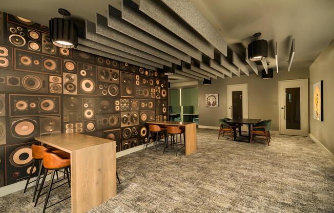 A shared lounge with acoustic detailing, communal tables, and flexible seating designed for collaboration, creativity, and focused moments throughout the day.