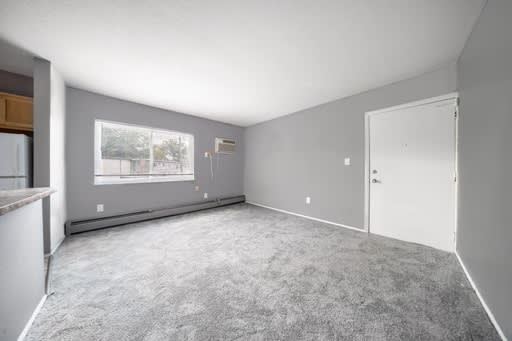 a living room with gray walls and a white door