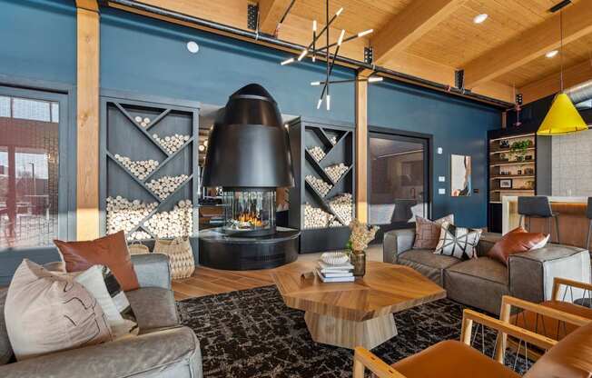 A modern living room with a fireplace and a large rug.