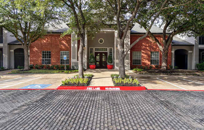 A brick building with a red brick walkway in front of it.