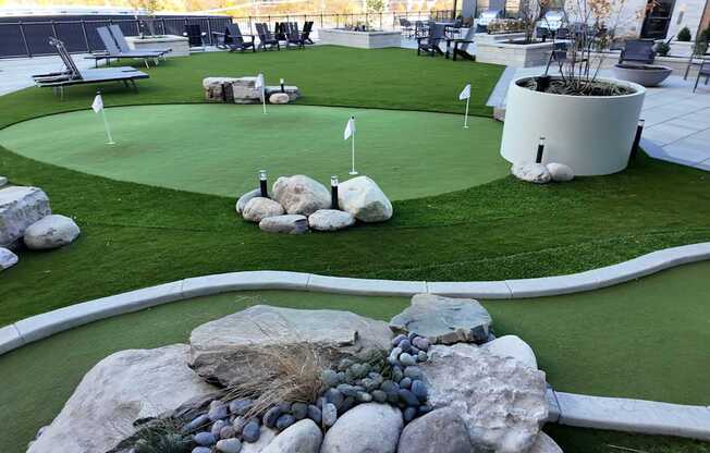 A miniature golf course with a white flag on the green. at The Pearl, Fort Wayne, 46802