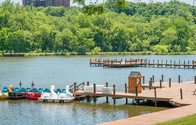 a dock with boats on the water at a lake