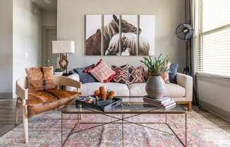 a living room filled with furniture and a large window