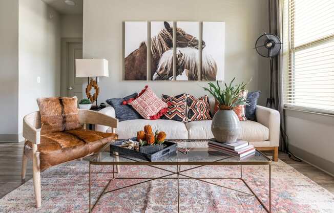 a living room filled with furniture and a large window