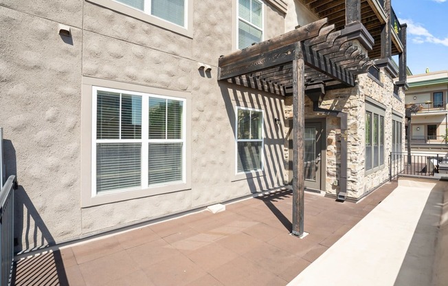 a building with a stone facade and a wooden walkway in front of it