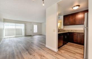 Vacant apartment home located on the first floor with hardwood inspired flooring through out. Kitchen is off to the side with draker cabinets, granite counters, and all major kitchen appliances. 