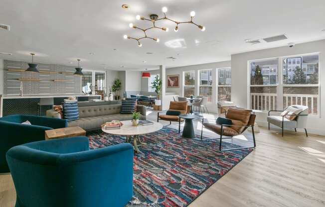 a living room with couches and chairs and a large rug