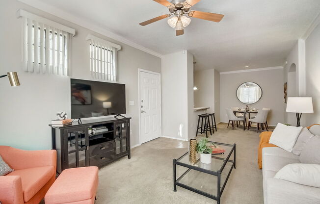 a living room with a ceiling fan and a tv at Adiamo Palm Valley, Goodyear, AZ