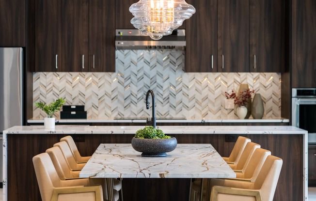 a kitchen with a marble table and chairs  at The Clearing at ONE28, Olathe, KS, 66062