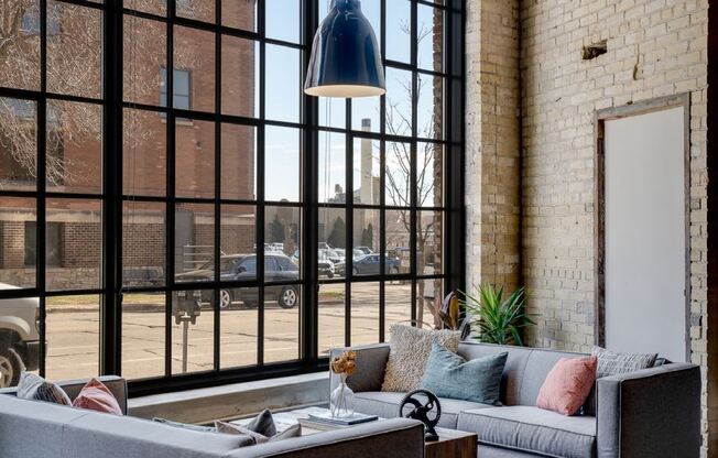 Exposed brick and warehouse windows in restored lobby space
