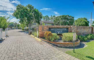 The image shows a brick wall with a sign that reads "Westminster Chase."