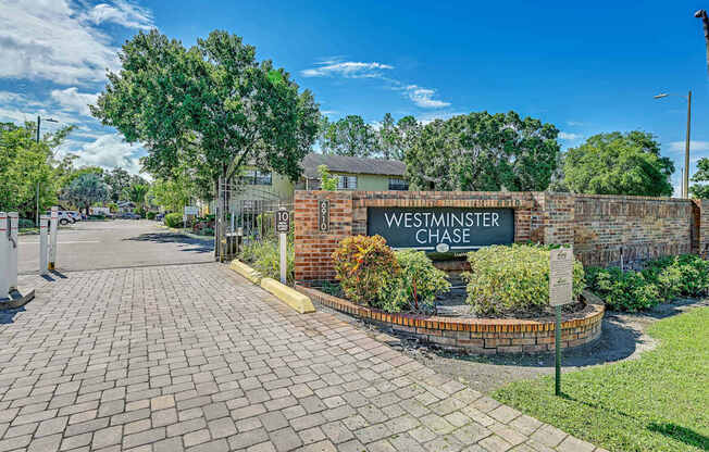 The image shows a brick wall with a sign that reads "Westminster Chase."