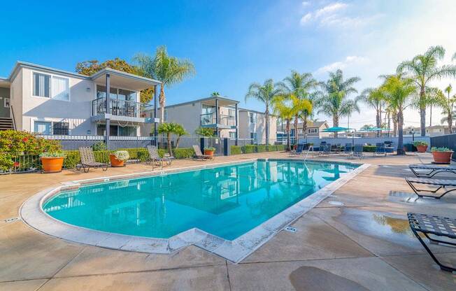 a swimming pool with a building in the background at Park Avenue Apartments, Long Beach, CA, 90815