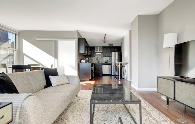 a living room with a couch and a glass table