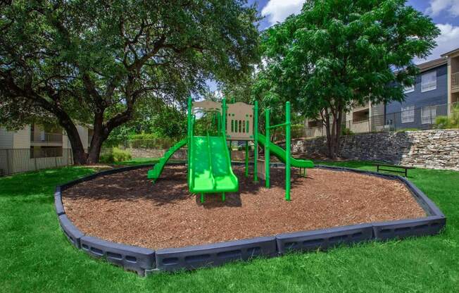 A green playground in a residential area.