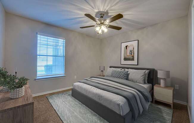 A bedroom with a bed, nightstand, and a ceiling fan.