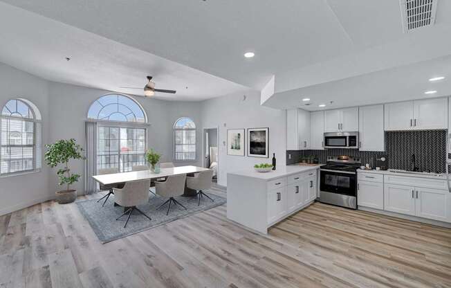 A modern kitchen with a dining table and chairs.