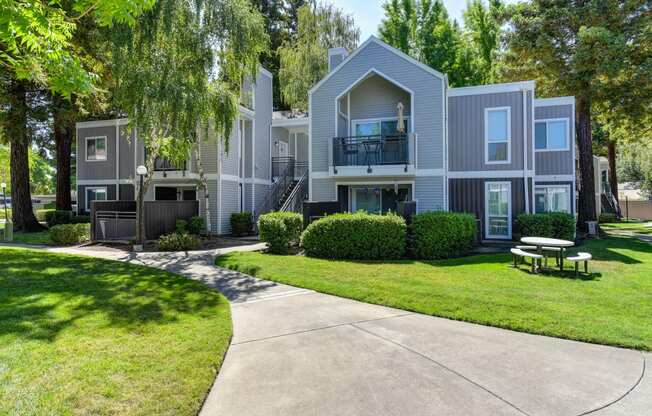 Apartment Exterior with Walkway, Grass and Trees