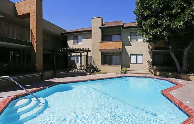 A swimming pool in front of a building with a red border.