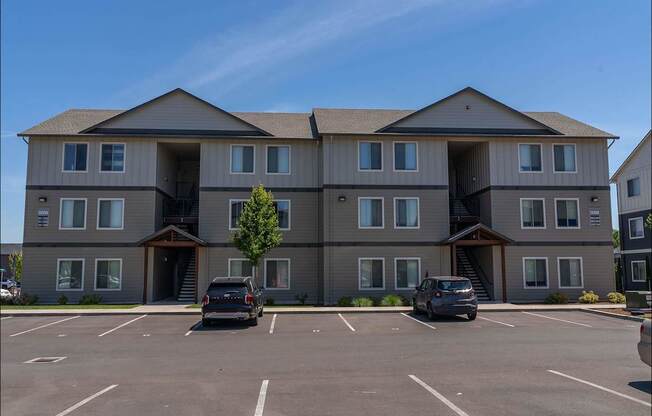 A large building with a parking lot in front of it at Northplace Apartment Homes, Oregon