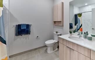 Bright and modern bathroom with elegant fixtures and ample storage space at The Mint Rahway, ideal for a luxury apartment rental.