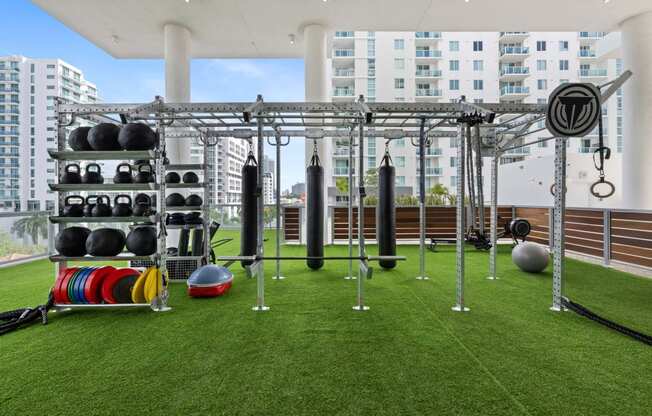 a gym on the roof of a building with weights and other equipment