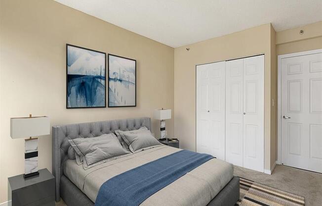 Modern bedroom with closet, queen sized bed, and carpet at Prospect Place, NJ 07601