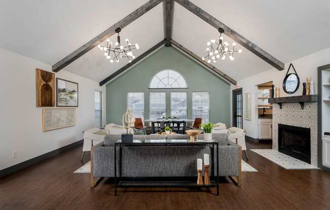 high ceiling club house with sofa and fireplace