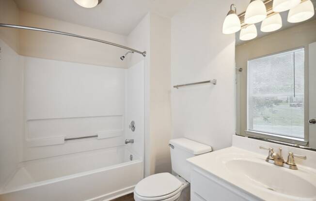 a bathroom with a sink toilet and a bath tub