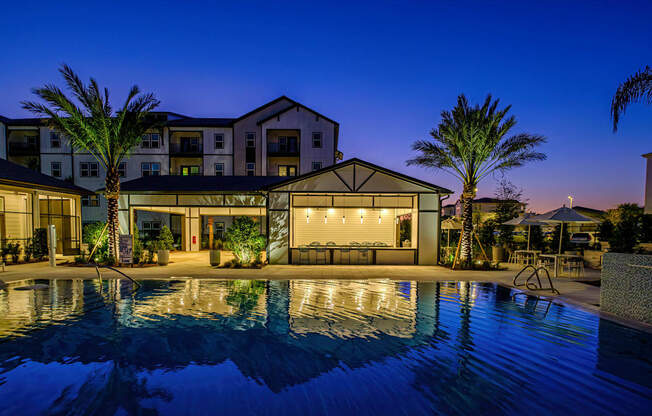 A modern house with a pool in the foreground.