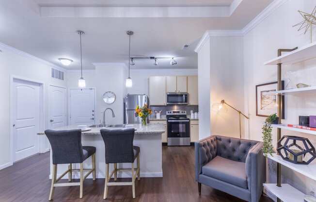 a living room with a kitchen and a couch and a table