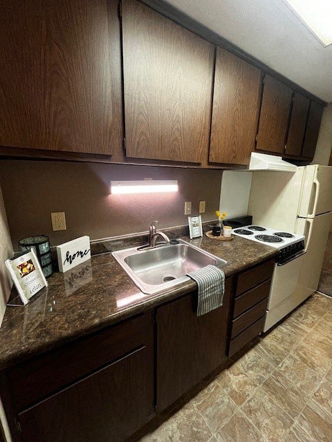 a kitchen with a sink and a stove and cabinets