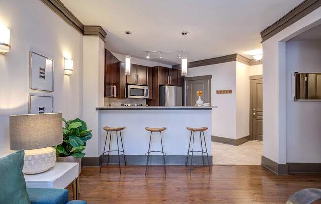 A kitchen with a bar area and a couch.